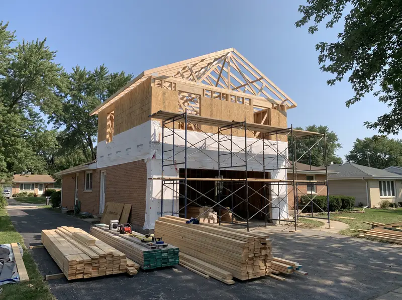 Second-story addition being framed on a suburban ranch house