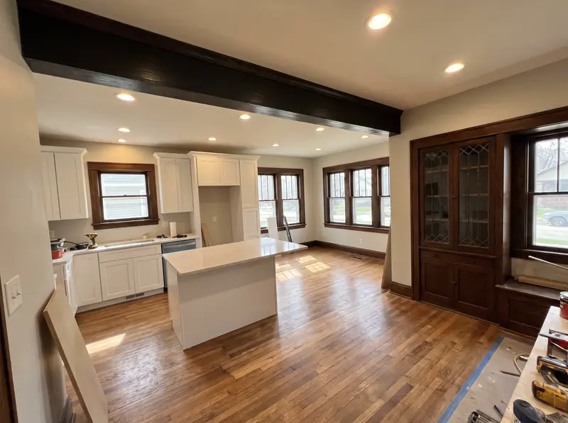 Open kitchen after removing a wall, with a new beam where the wall was